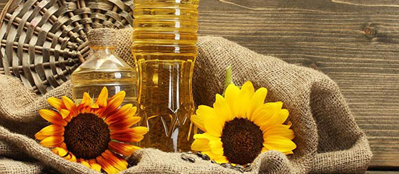 orange and yellow sunflower and sunflower oil on jute bag