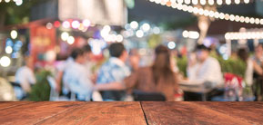 table with background of people and bokeh